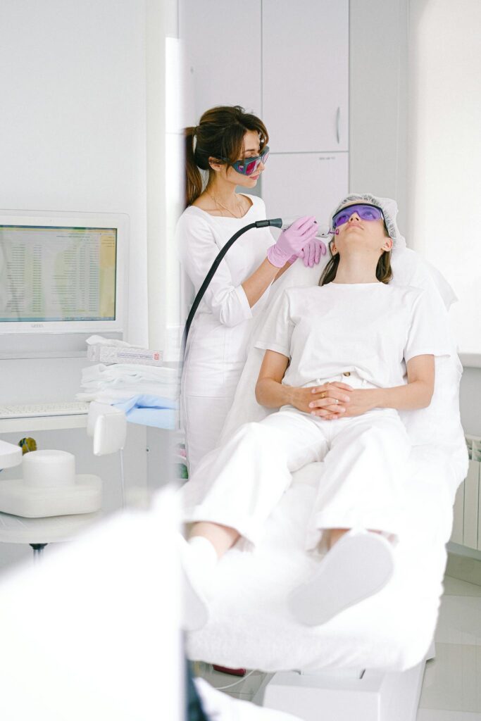 Effective Blog Promotion: Strategies to Increase Your Reach Two women in a clinic during a laser facial treatment, ensuring skincare and beauty.